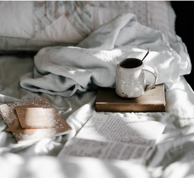 book and coffee on bed