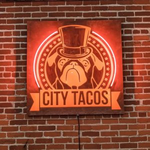 neon sign of City Taco's logo
